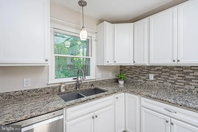 a bathroom with a tub a window and a shower