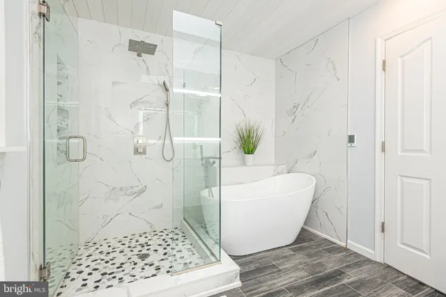 a bedroom with a bed and a potted plant