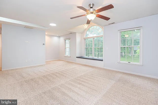 a bathroom with a granite countertop toilet a sink and mirror