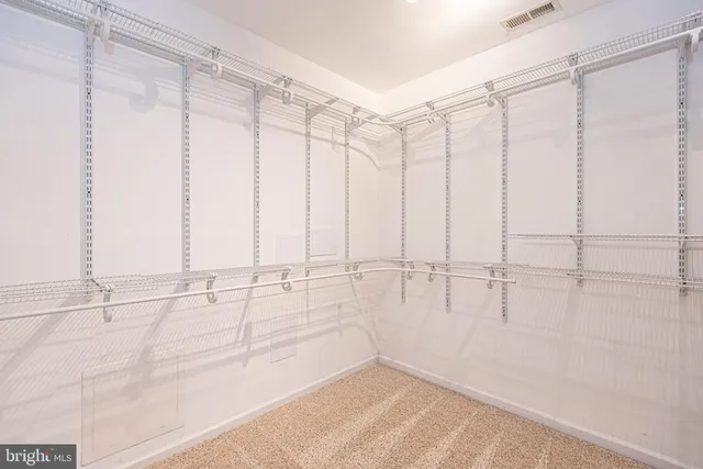 a living room with furniture a flat screen tv and kitchen view