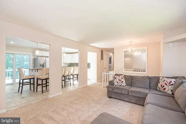 a kitchen with stainless steel appliances granite countertop a kitchen island a stove a table and chairs