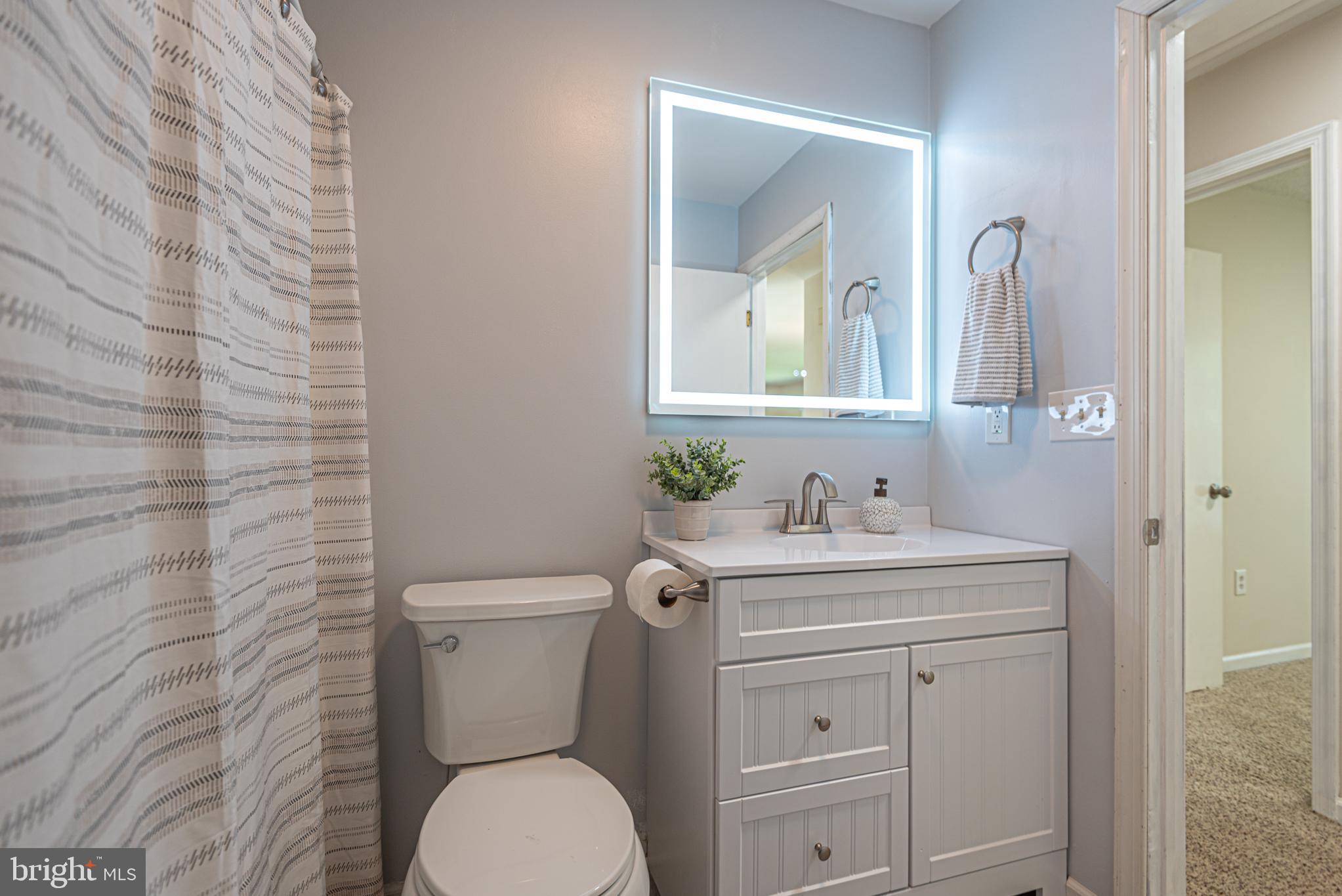 74 Birdnest Drive Ocean Pines, MD 21811 - Photo 42 of 89 a bathroom with a granite countertop toilet sink and mirror
