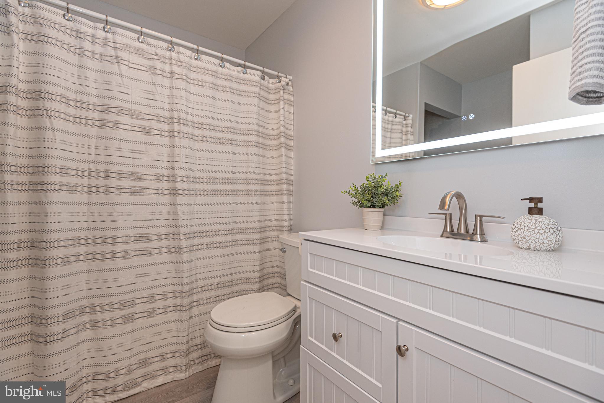 74 Birdnest Drive Ocean Pines, MD 21811 - Photo 44 of 89 a bathroom with a sink a toilet and mirror