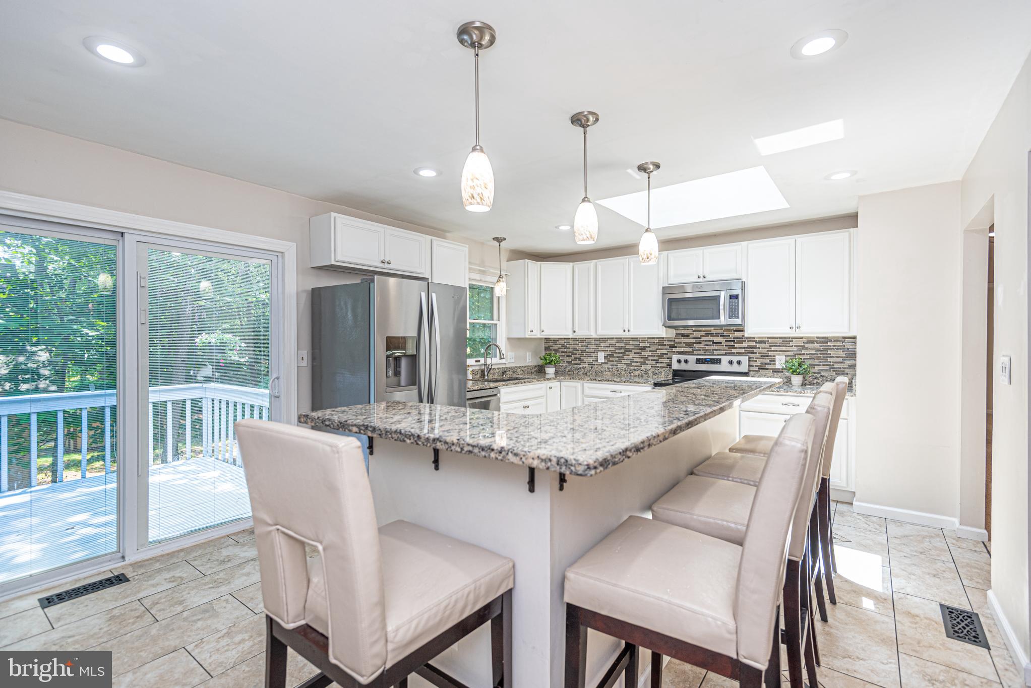 74 Birdnest Drive Ocean Pines, MD 21811 - Photo 5 of 89 a kitchen with stainless steel appliances granite countertop a kitchen island a stove a table and chairs