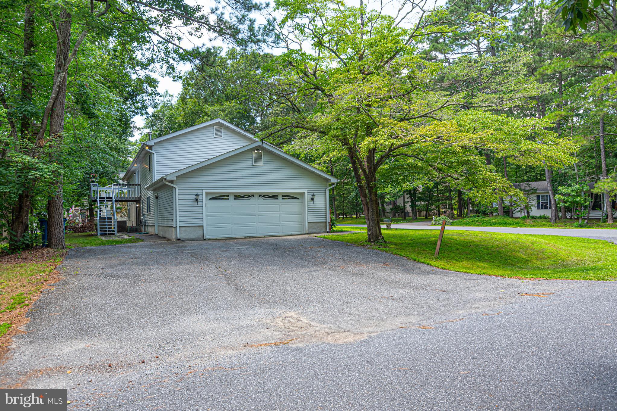 74 Birdnest Drive Ocean Pines, MD 21811 - Photo 77 of 89 a view of a house with a yard and large trees