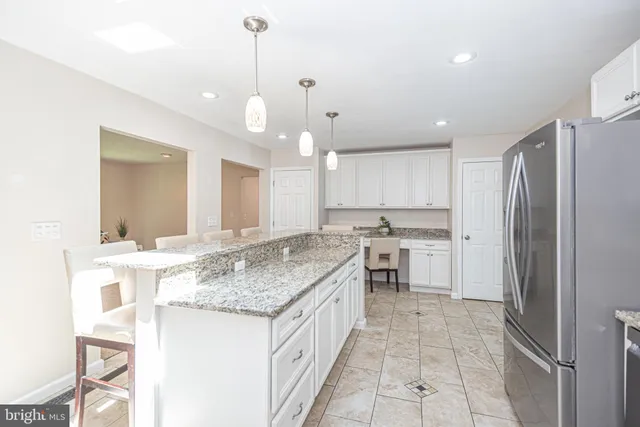 a kitchen with cabinets appliances a sink and a counter top space