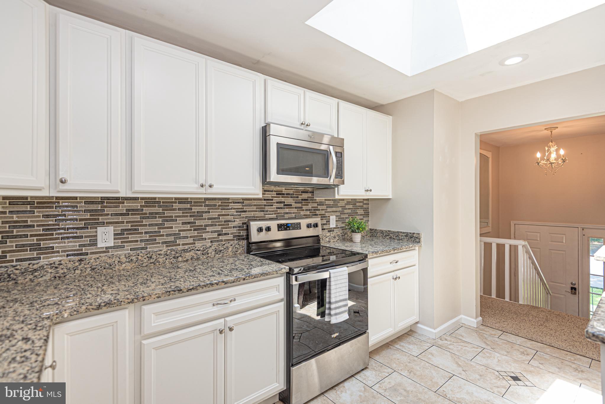 74 Birdnest Drive Ocean Pines, MD 21811 - Photo 10 of 89 a kitchen with granite countertop a stove sink and cabinets