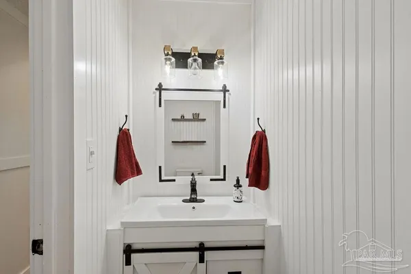 a bathroom with a sink and a mirror
