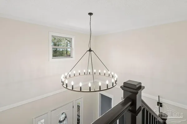 a view of a hallway with a table and chairs