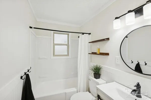 a bathroom with a shower curtain and a sink