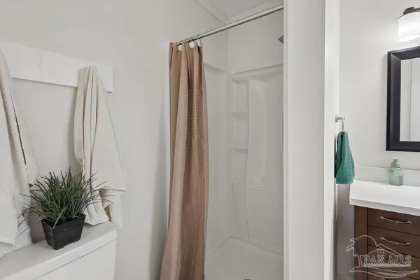a bathroom with a shower curtain and toilet