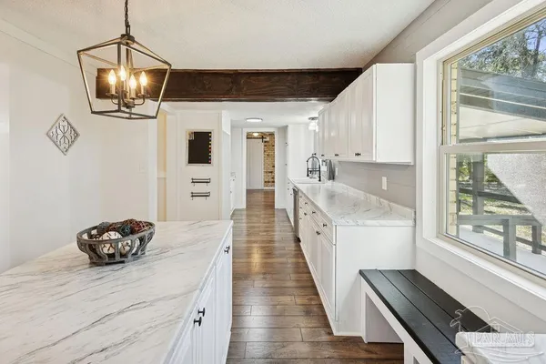 a hallway with a view of dining room and wooden floor