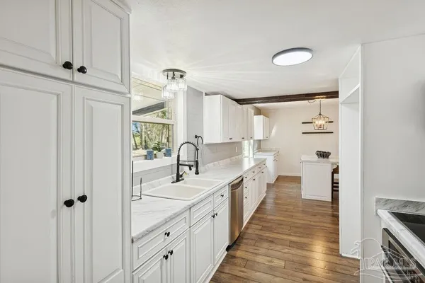 a kitchen with appliances cabinets and a counter top space
