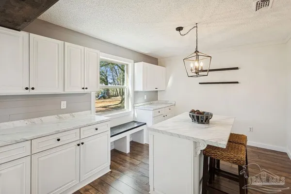 a view of staircase with railing and white walls