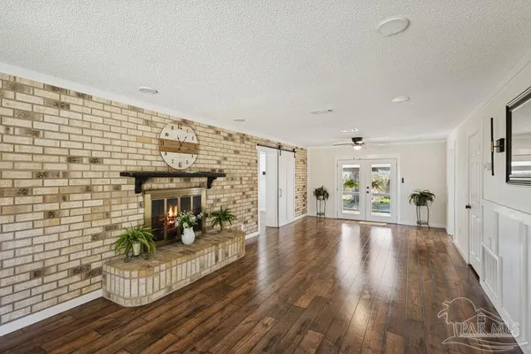 a view of empty room with wooden floor