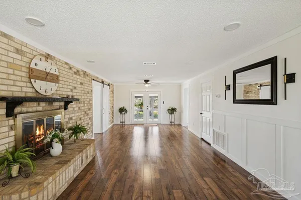 a view of a livingroom with wooden floor and a window