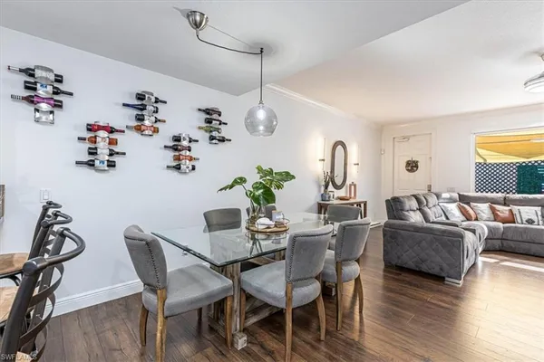 a view of a dining room with furniture wooden floor and chandelier