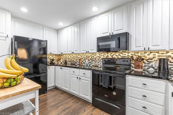 a kitchen with granite countertop wooden cabinets and stainless steel appliances