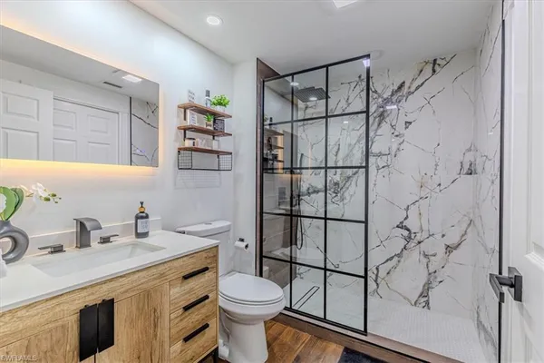 a bathroom with a sink toilet and shower