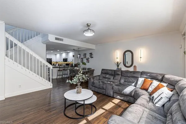 a living room with furniture and a dining table