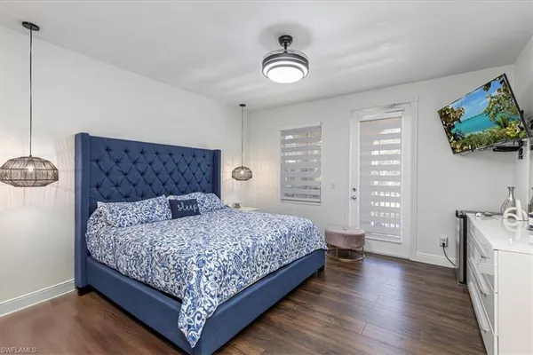 a bedroom with a large bed and a window