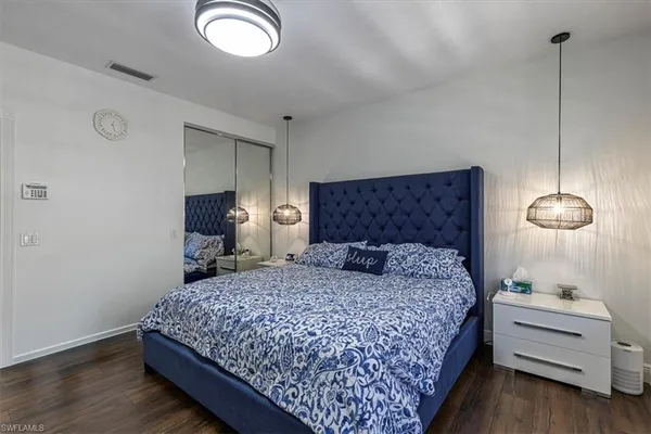 a bedroom with a bed and a night stand