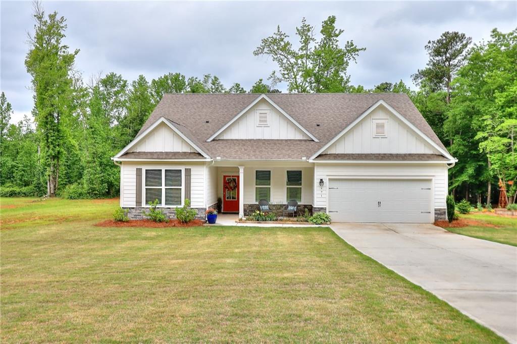 a front view of a house with a yard table and chairs