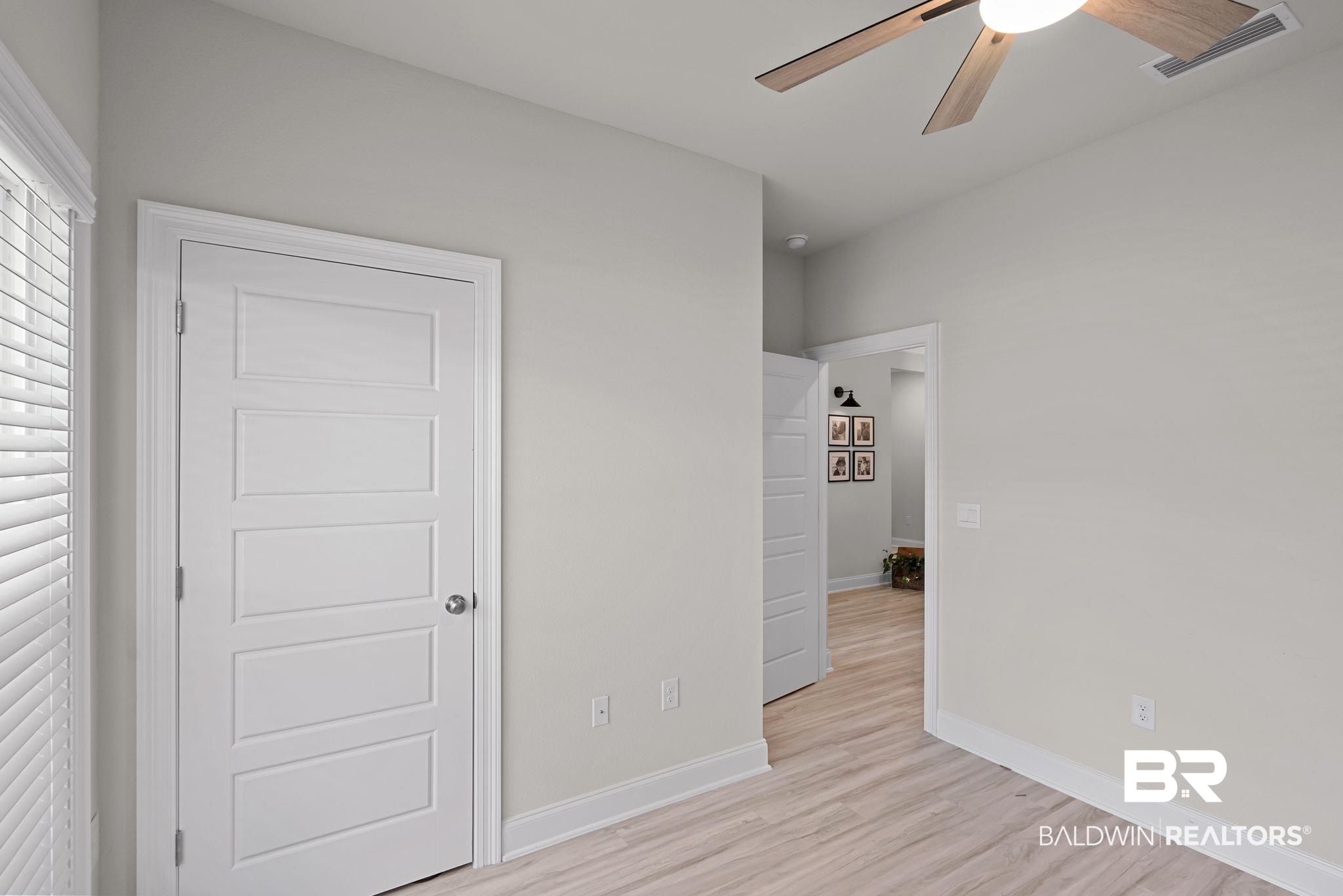 13966 Antler Hl Road Daphne, AL 36527 - Photo 28 of 44 Room featuring wood-finish flooring, light grey walls, and white trim