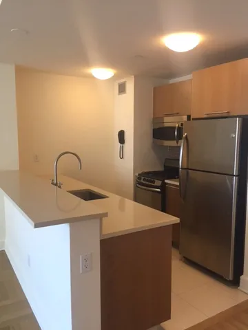 a kitchen with a refrigerator and a sink