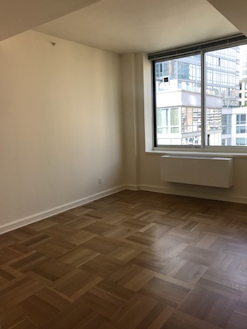 400 West 63rd Street, Unit 1505 Manhattan, NY 10069 - Photo 6 of 8 a view of an empty room with a window