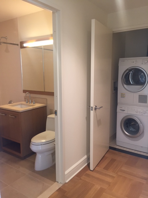400 West 63rd Street, Unit 1505 Manhattan, NY 10069 - Photo 7 of 8 a bathroom with a toilet sink and mirror