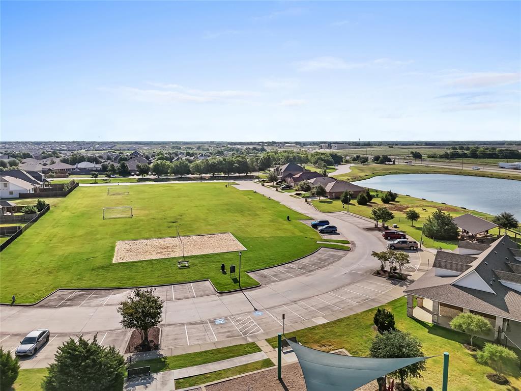 2920 Roper Street Royse City, TX 75189 - Photo 27 of 29 Expansive green space featuring a sand volleyball court, soccer goals, and a paved parking area