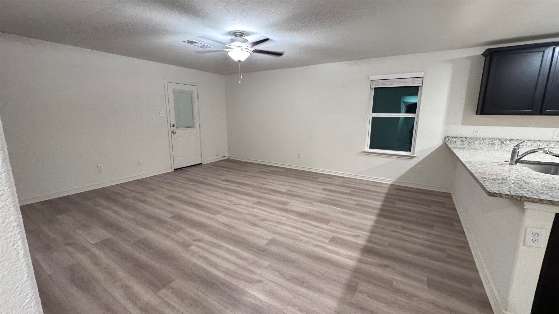 14421 Prairie Sod Lane Elgin, TX 78621 - Photo 5 of 10 Functional open layout with durable laminate flooring and a ceiling fan for year-round comfort.