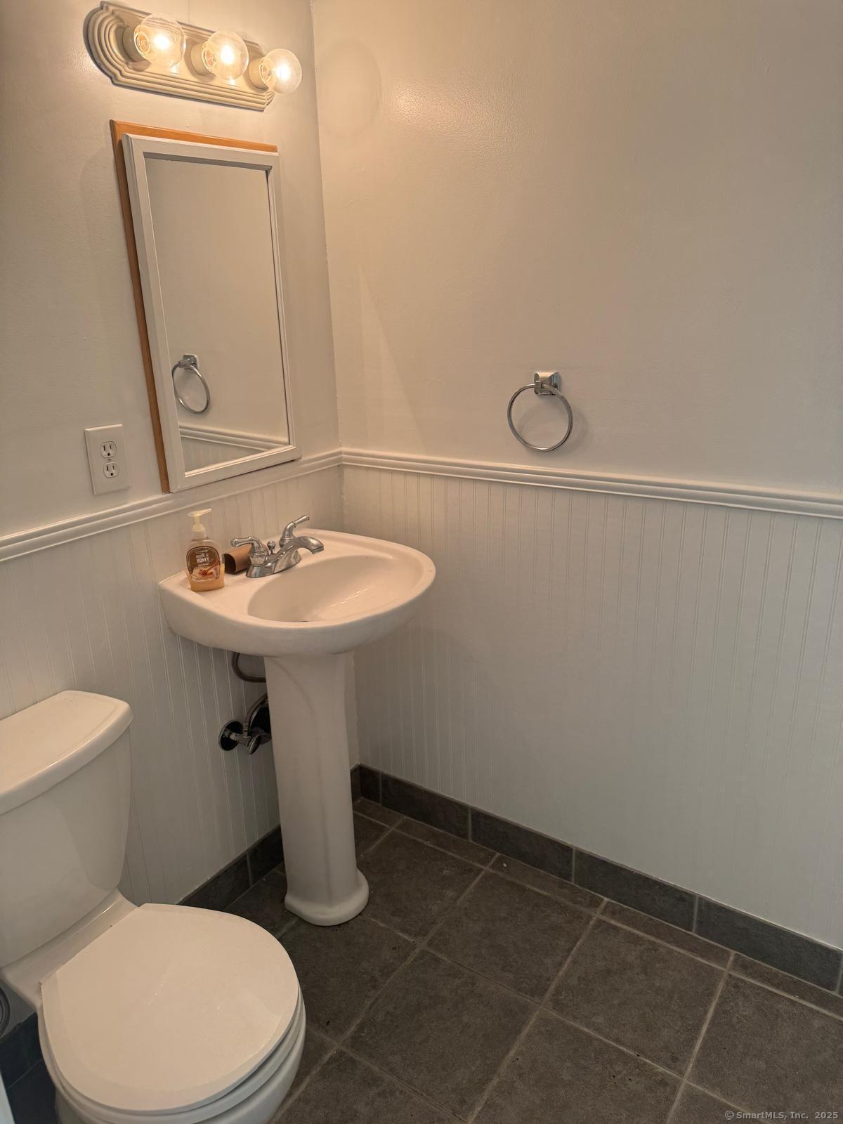 18 Hales Road Westport, CT 06880 - Photo 18 of 26 a bathroom with a sink toilet and mirror