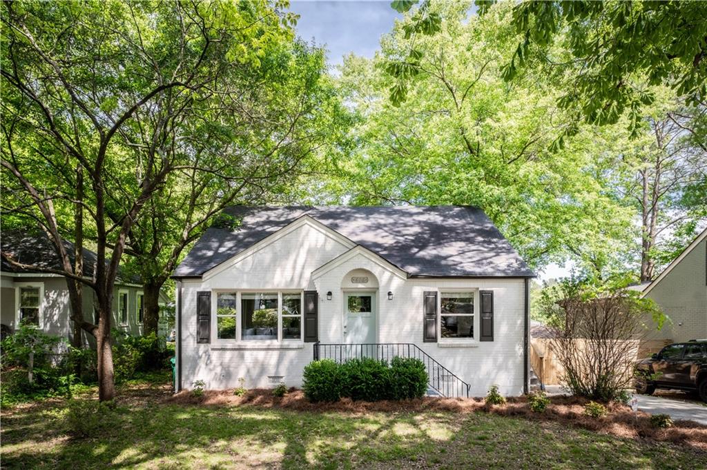 610 Quillian Avenue Decatur, GA 30032 - Photo 1 of 1 a white house sitting in middle of a yard