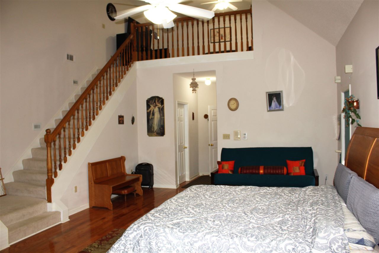 355 Forest Hill-Irene Road Memphis, TN 38018 - Photo 13 of 25 a bedroom with bed and a table with potted plants