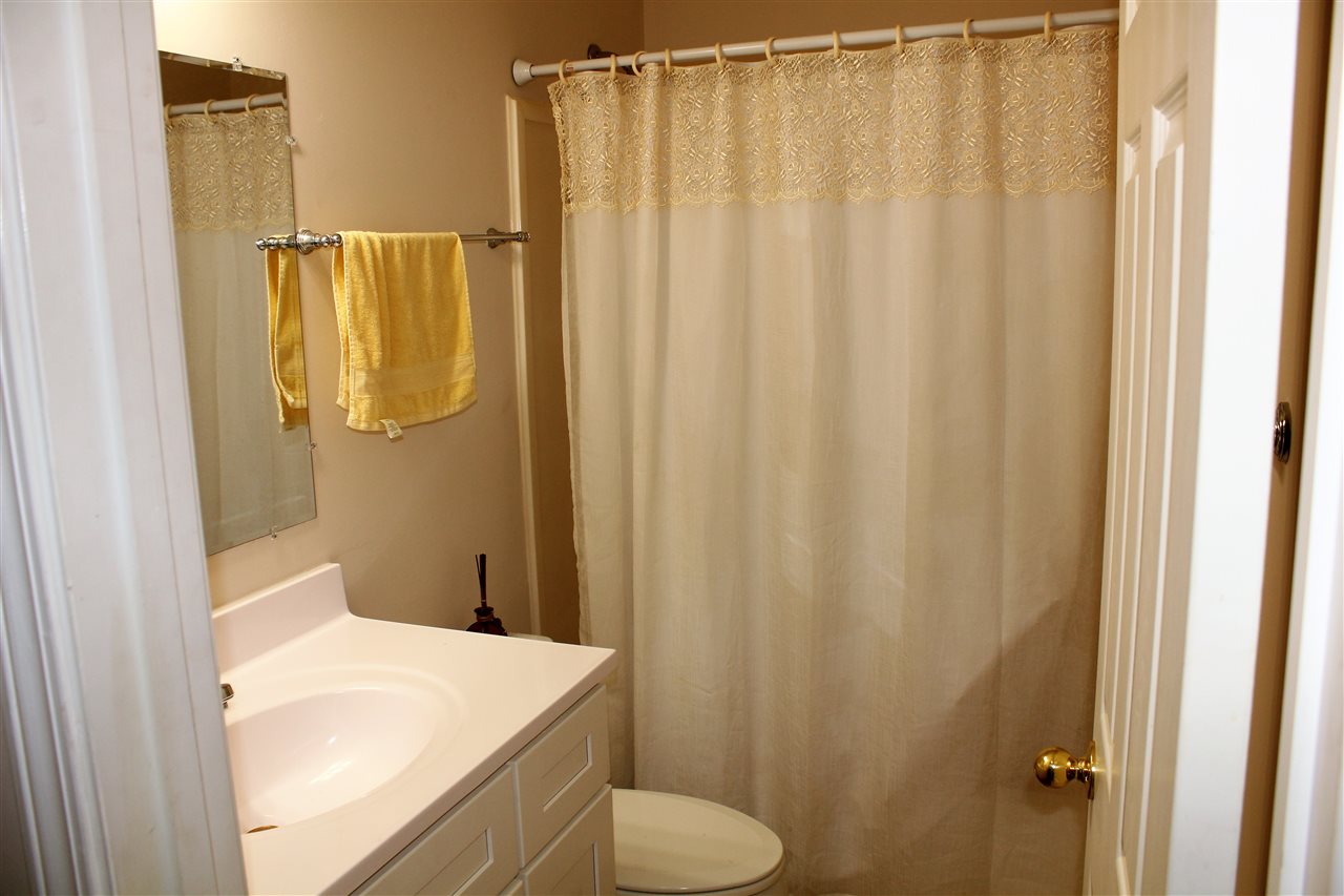 355 Forest Hill-Irene Road Memphis, TN 38018 - Photo 19 of 25 a bathroom with a shower curtain and sink