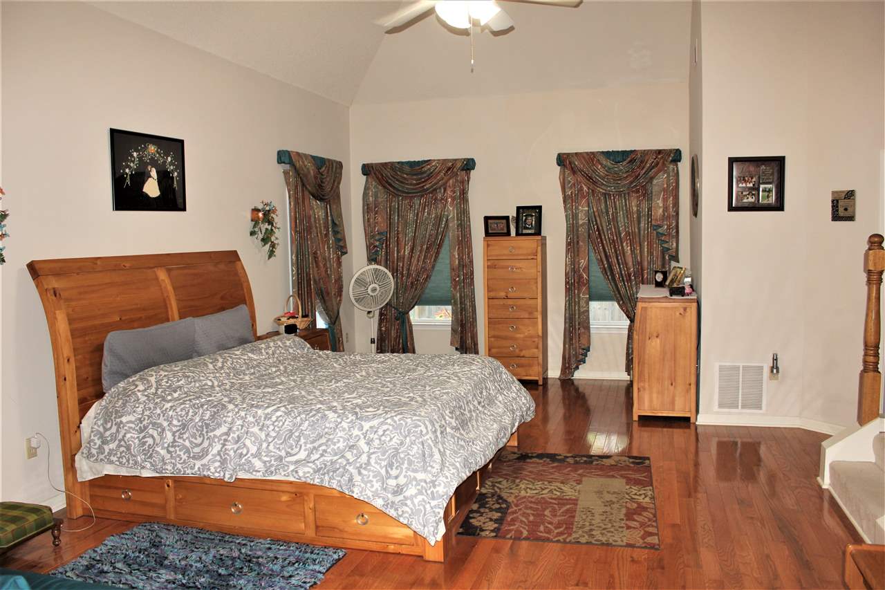 355 Forest Hill-Irene Road Memphis, TN 38018 - Photo 10 of 25 a bedroom with a bed and wooden floor