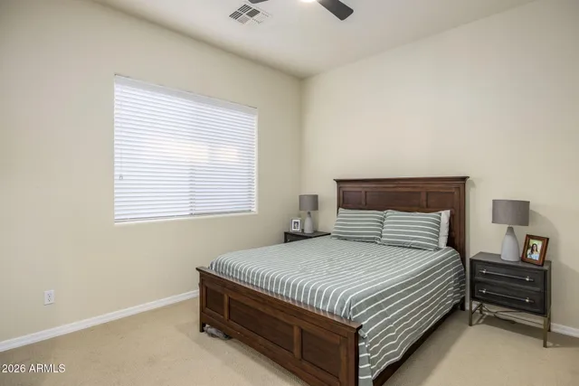 a bedroom with a bed and a night stand