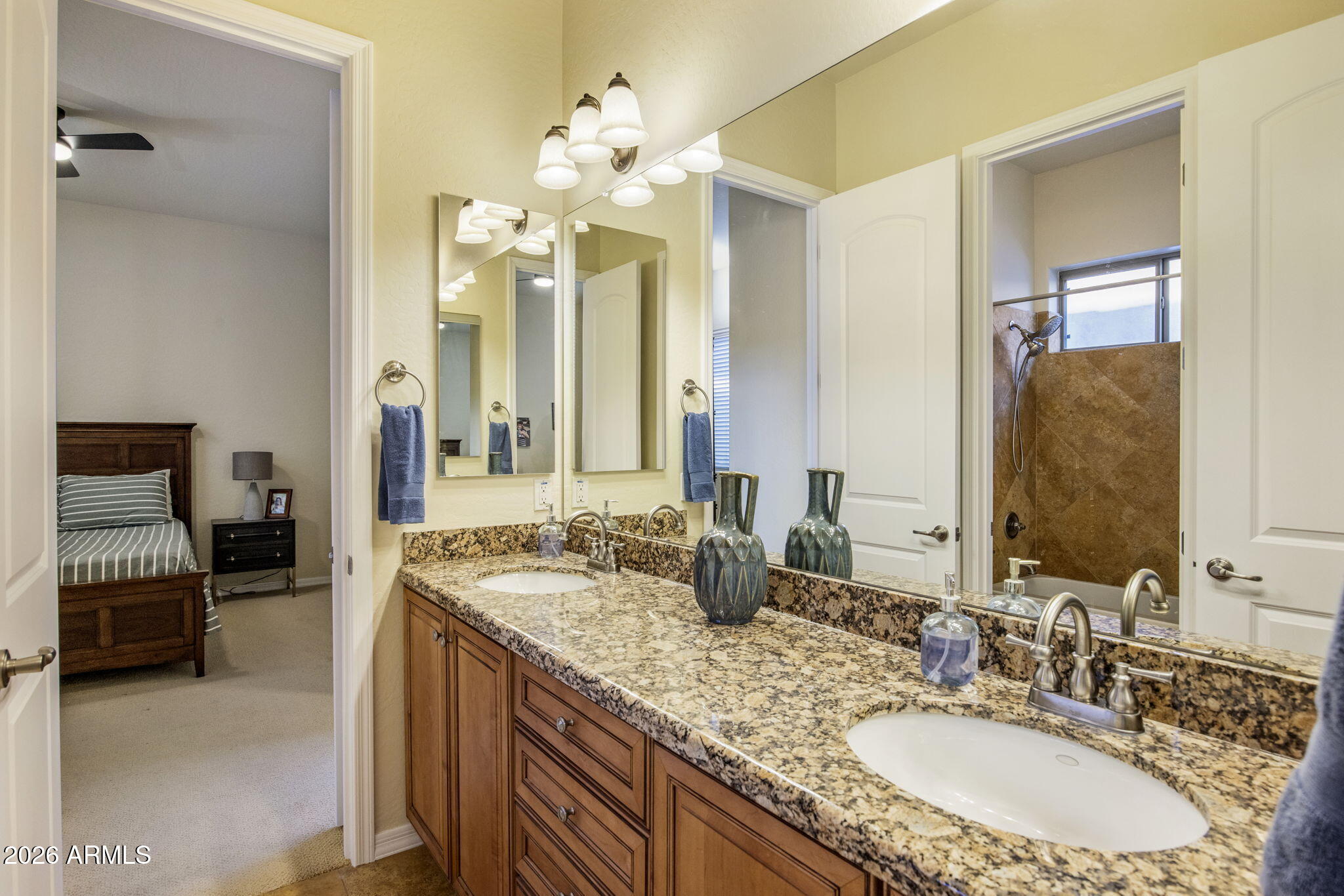 14112 North 12th Street Phoenix, AZ 85022 - Photo 25 of 46 a bathroom with a granite countertop sink a large mirror and a shower