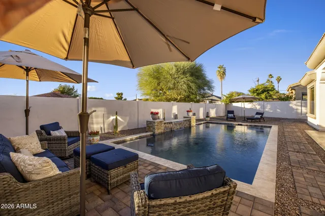 a living room with furniture and a floor to ceiling window