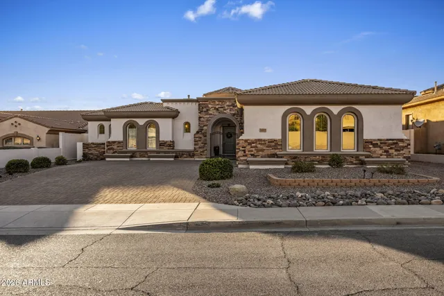 an aerial view of a house with a swimming pool and outdoor space