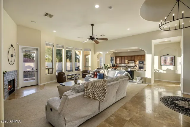 a living room with furniture and a chandelier