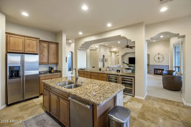 a kitchen with stainless steel appliances granite countertop a stove refrigerator and cabinets