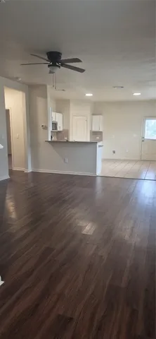 a view of a room with wooden floors