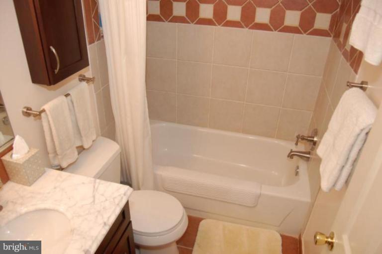 13114 Broadmore Road Silver Spring, MD 20904 - Photo 12 of 22 a white toilet sitting next to a bath tub