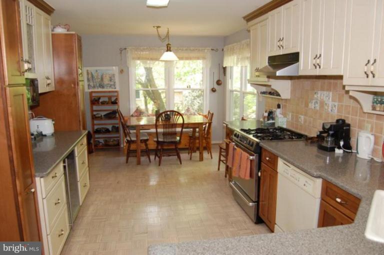 13114 Broadmore Road Silver Spring, MD 20904 - Photo 13 of 22 a kitchen with stainless steel appliances granite countertop a stove and a refrigerator