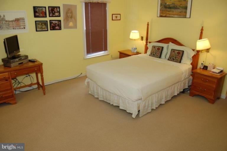 13114 Broadmore Road Silver Spring, MD 20904 - Photo 15 of 22 a bedroom with a bed and lamp on table