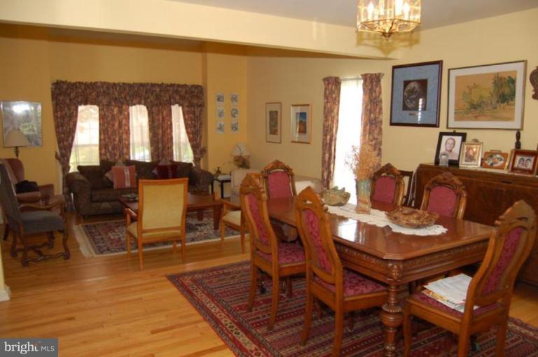 13114 Broadmore Road Silver Spring, MD 20904 - Photo 20 of 22 a view of a dining room with furniture a chandelier and wooden floor