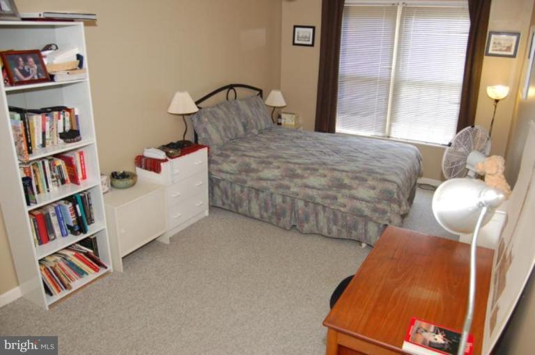 13114 Broadmore Road Silver Spring, MD 20904 - Photo 4 of 22 a bedroom with furniture and a book shelf